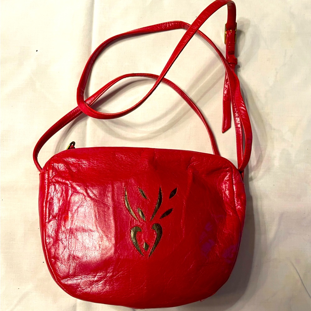 Small red leather crossbody bag.